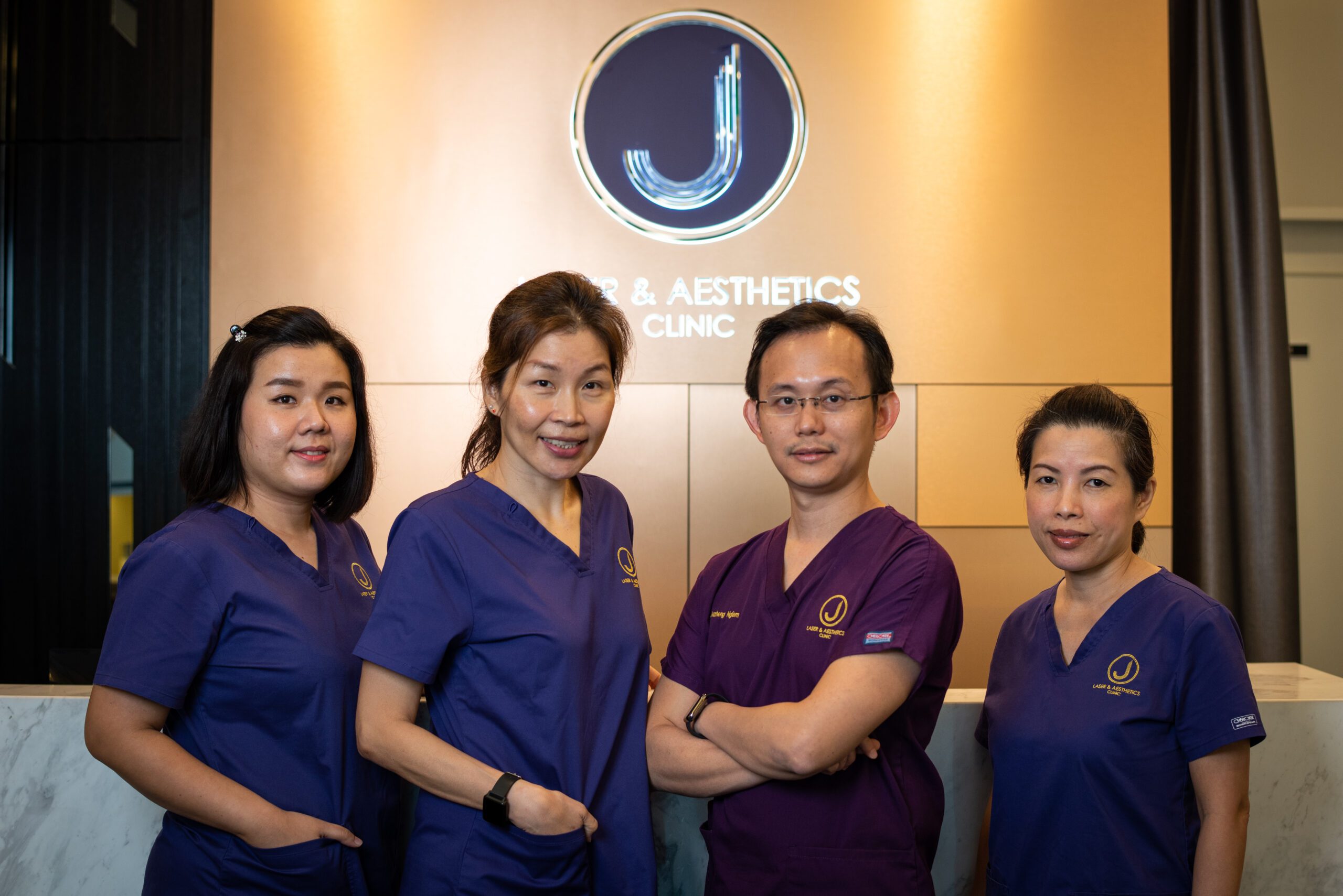 aesthetic doctor ngiam juzheng and team in clinic uniforms
